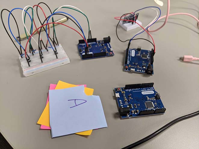 three arduino leonardo boards with sticky notes to identify its corresponding keypress for the unity game